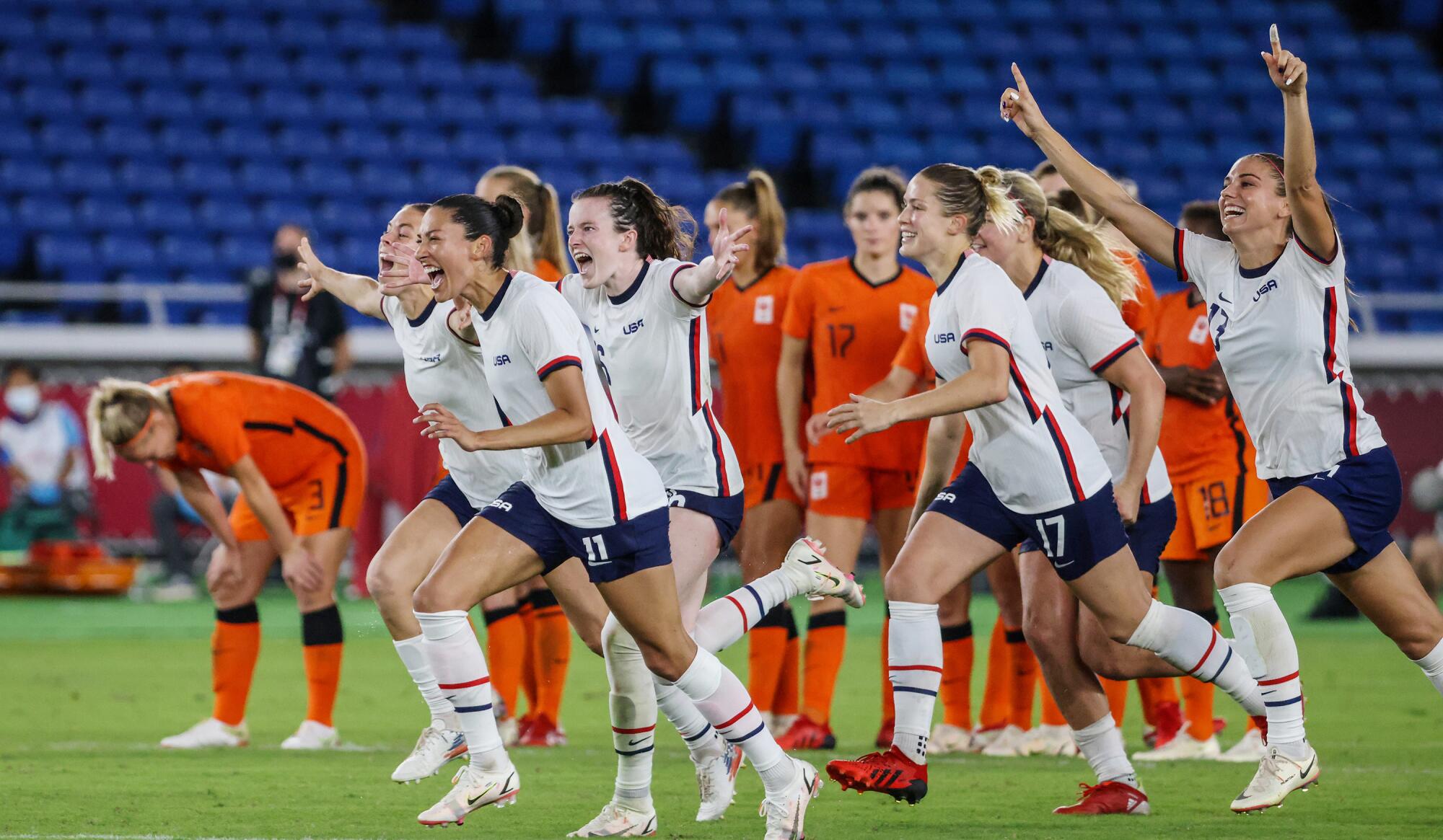 USA teammates rush to congratulate Megan Rapino and team goalkeeper Alyssa Naeher.