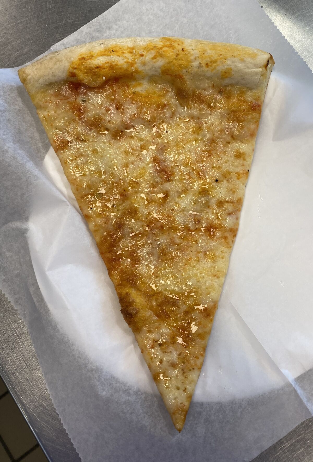 The success of Levitan’s time-restricted diet depends on never thinking of delicious cheesy slices of pizza like this one from Mr. Moto Pizza House, 617 Pearl St.