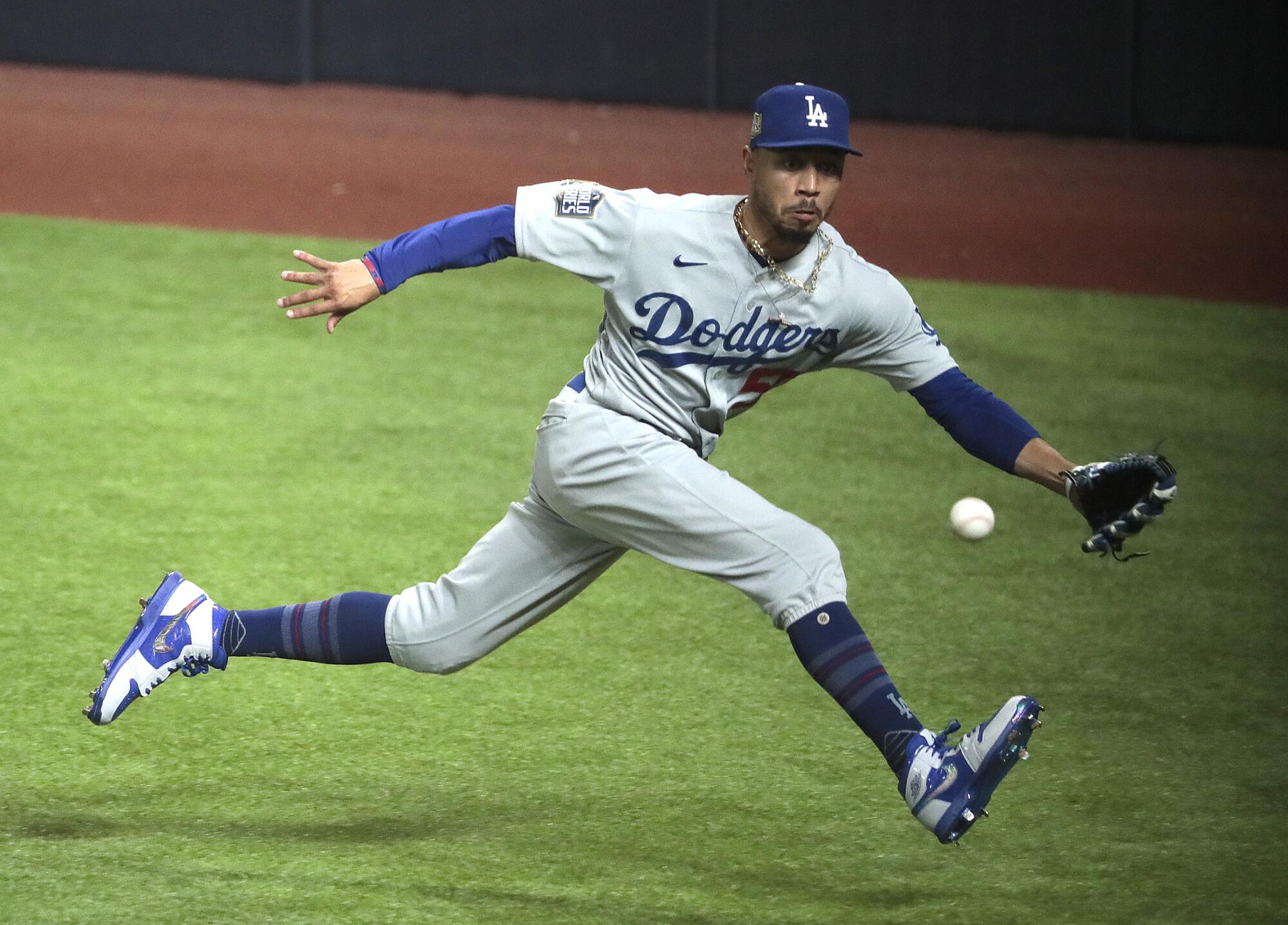 Dodgers right fielder Mookie Betts tracks down a third-inning RBI triple by Tampa Bay Rays first baseman Yandy Diaz.