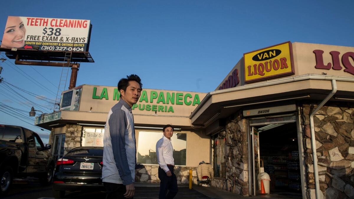 Justin Chon, left, and his father Sang Chon, whose shoe store in Paramount, CA was looted in the riots. The elder Chon also plays a pivotal role in "Gook."