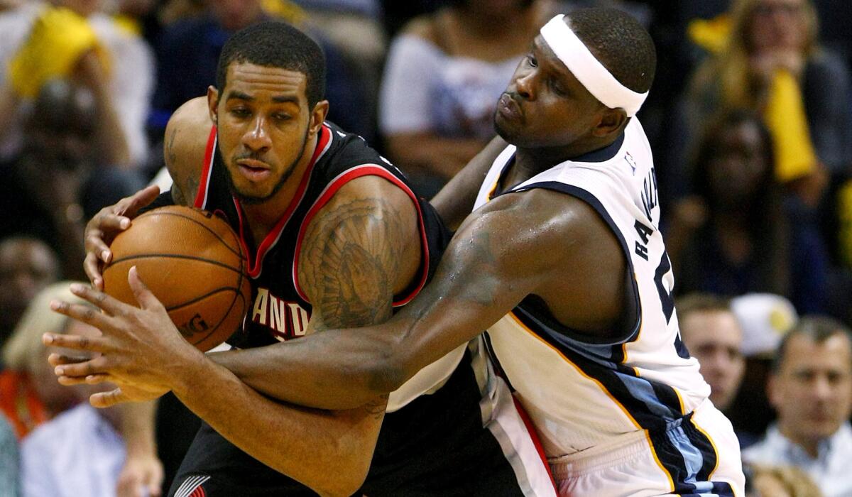 Grizzlies forward Zach Randolph tries to steal the ball from Trail Blazers forward LaMarcus Aldrdige during the second half of their playoff game Wednesday night.