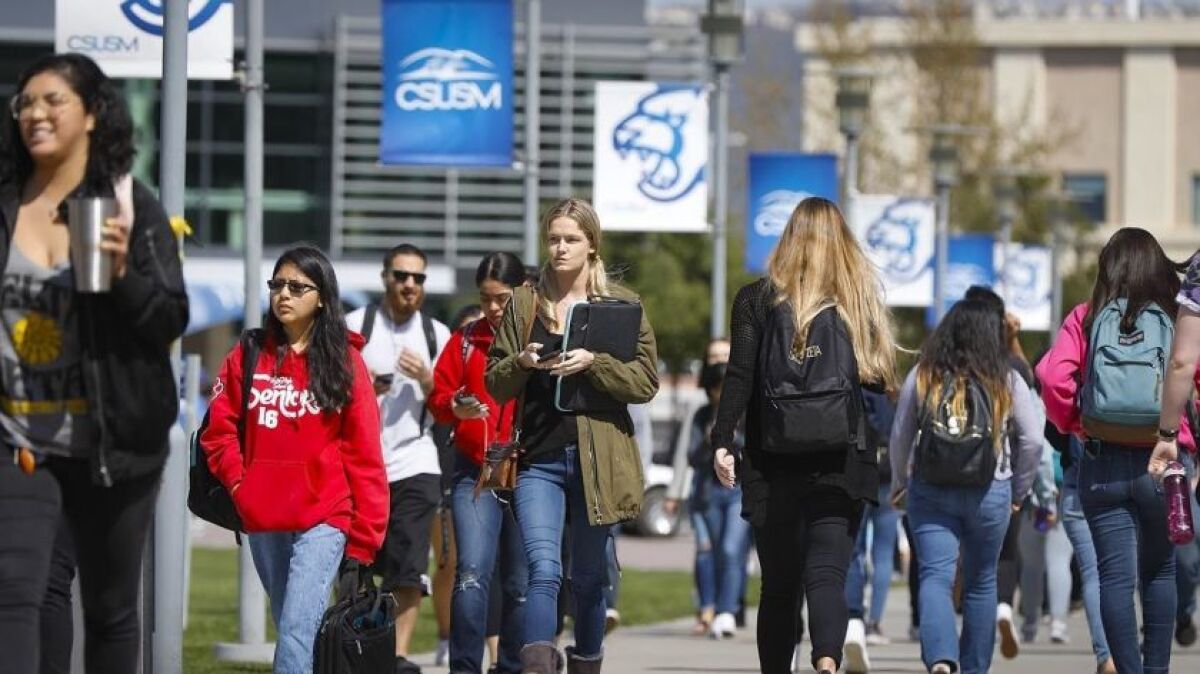 Students walk on the Cal State San Marcos campus.