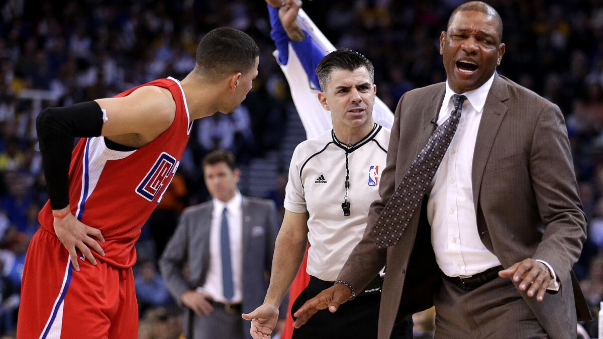 Coach Doc Rivers, right, reacts after a call went against the Clippers during a 112-108 loss to the Warriors on Wednesday night in Oakland.