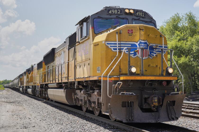 FILE - In this July 31, 2018, file photo a Union Pacific train travels through Union, Neb. Union Pacific's first-quarter profit declined 9% as the railroad delivered less freight and its revenue fell. A major fertilizer company says the limits Union Pacific is putting on rail traffic to clear up congestion will delay shipments that farmers need during the spring planting season. (AP Photo/Nati Harnik, File)