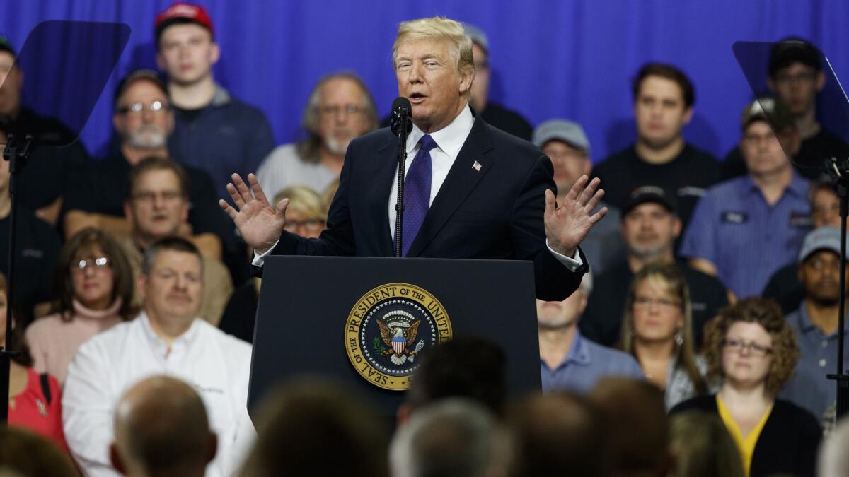 President Trump promotes his tax policy during a February 2018 visit to a company in Ohio. As he slashed corporate taxes, several firms promised bonuses for their employees.