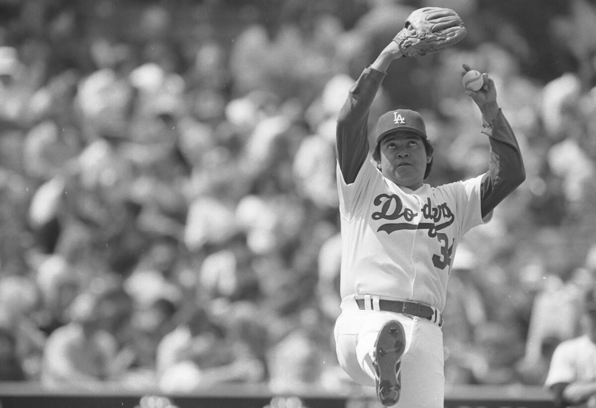 As Fernando Valenzuela winds up, his eyes roll up toward the sky.