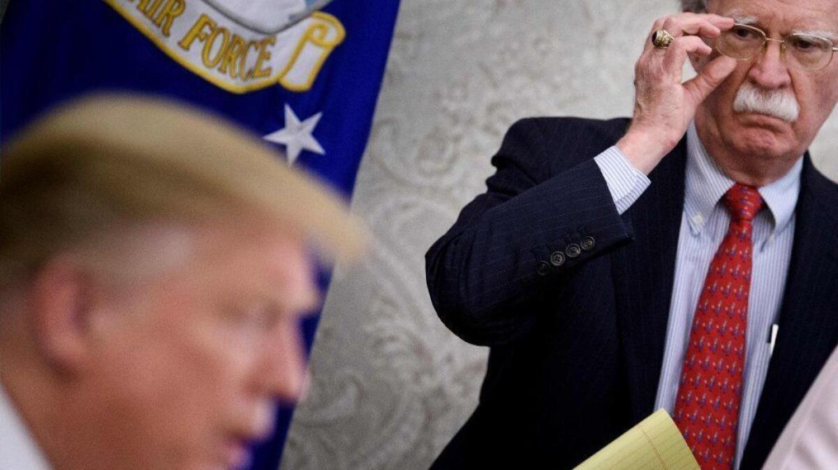 National security advisor John Bolton listens while President Trump speaks to the press at the White House on May 13.