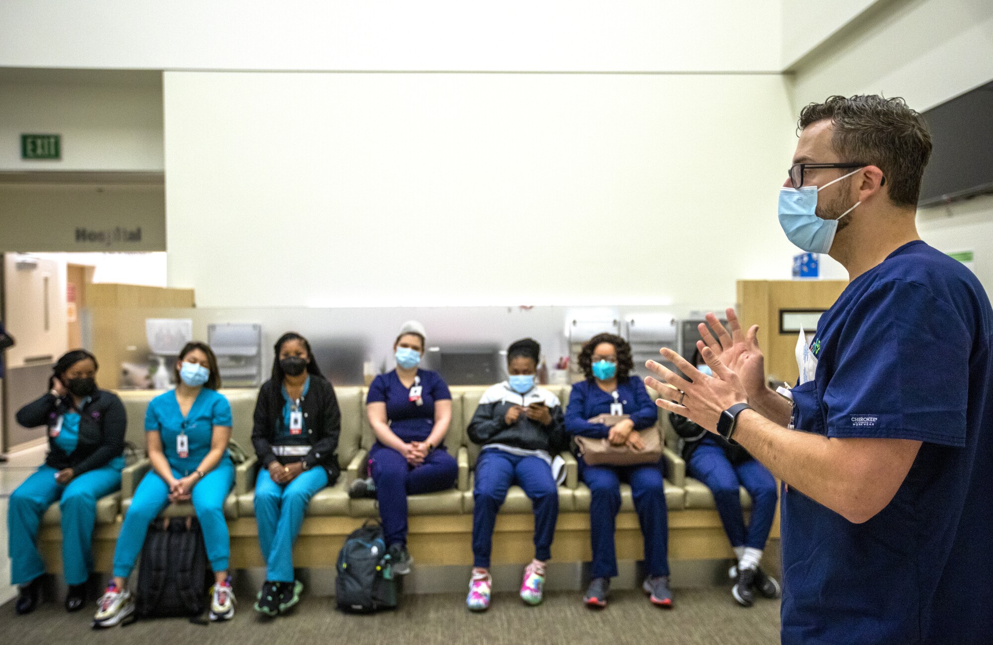 A nurse speaks to healthcare staff 