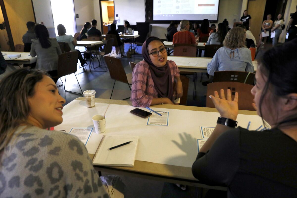 Local young people began drafting the county's first "youth master plan" in collaboration with local leaders and Youth Will. Here, Shadia Omer talks with Janet Ruiz of the San Diego American Indian Health Center and Maddy Moritsch of the Alliance for a Healthier Generation.