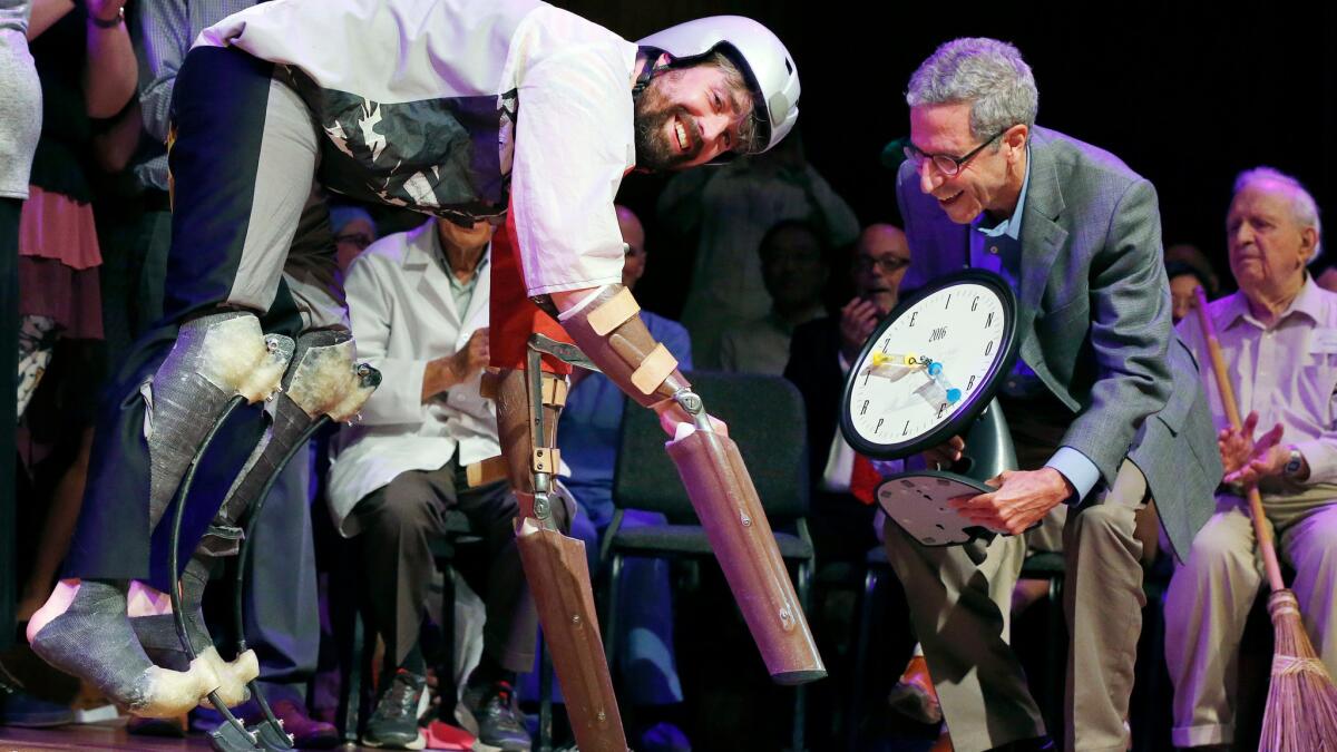 Thomas Thwaites, left, accepts the Ig Nobel Prize in biology from Nobel laureate Eric Maskin. Thwaites was honored for living among goats.