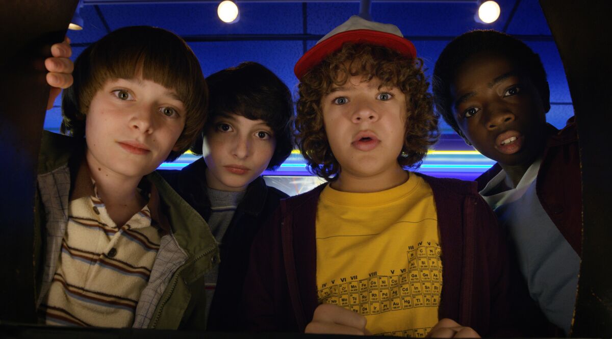 This image released by Netflix shows Noah Schnapp, from left, Finn Wolfhard, Gaten Matarazzo and Caleb Mclaughlin in a scene from "Stranger Things," premiering its second season on Friday. (Netflix via AP)
