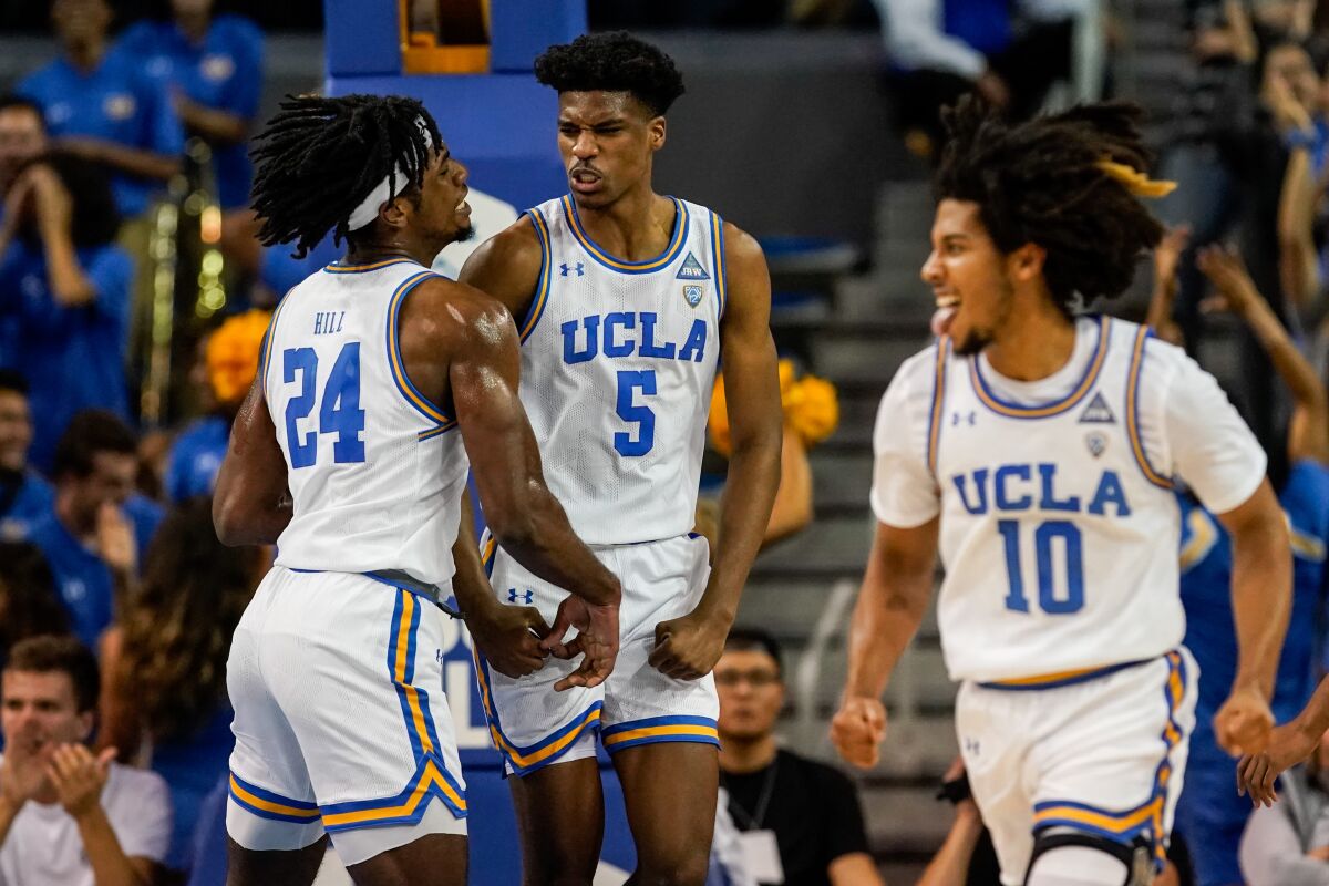 UCLA Bruins forward Jalen Hill (24) and guard Chris Smith (5) celebrate Smith scoring during the first half against Long Beach State at Pauley Pavillion on Nov. 6, 2019.