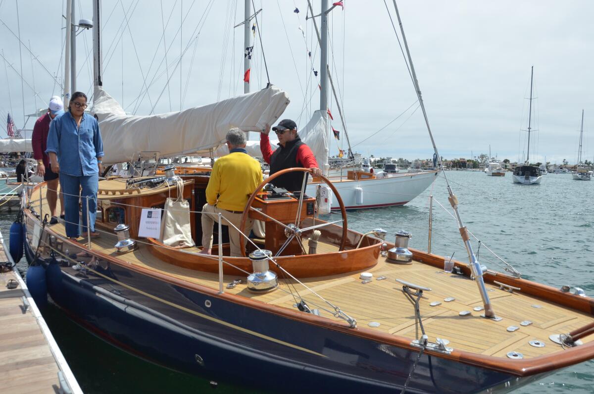 Newport Beach Wooden Boat Festival attendees tour the 50-foot Sprint yacht, Serendipitous.