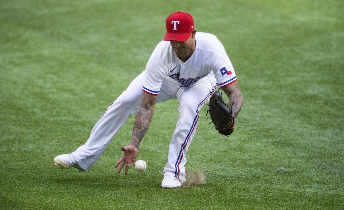 Texas Rangers relief pitcher Matt Bush (51) fields a hit by Toronto Blue Jays' Bo Bichette (11) during the eighth inning of a baseball game, Wednesday, April 7, 2021, in Arlington, Texas. Bush was unable to make the throw to first. (AP Photo/Brandon Wade)