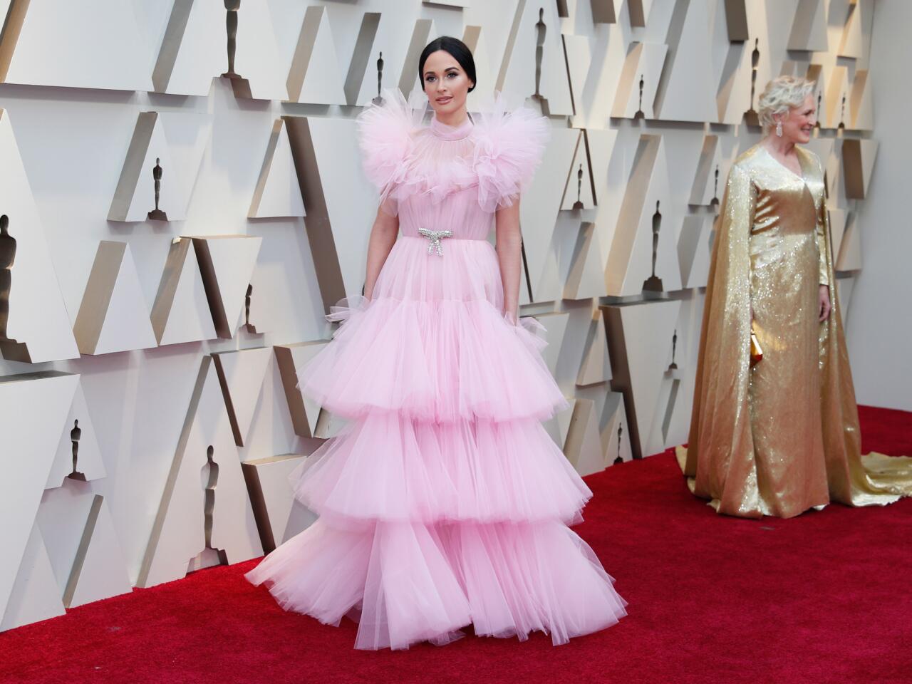MISS: Kacey Musgraves continues her pink awards season theme in a poufy, multi-tiered Giambattista Valli couture gown.