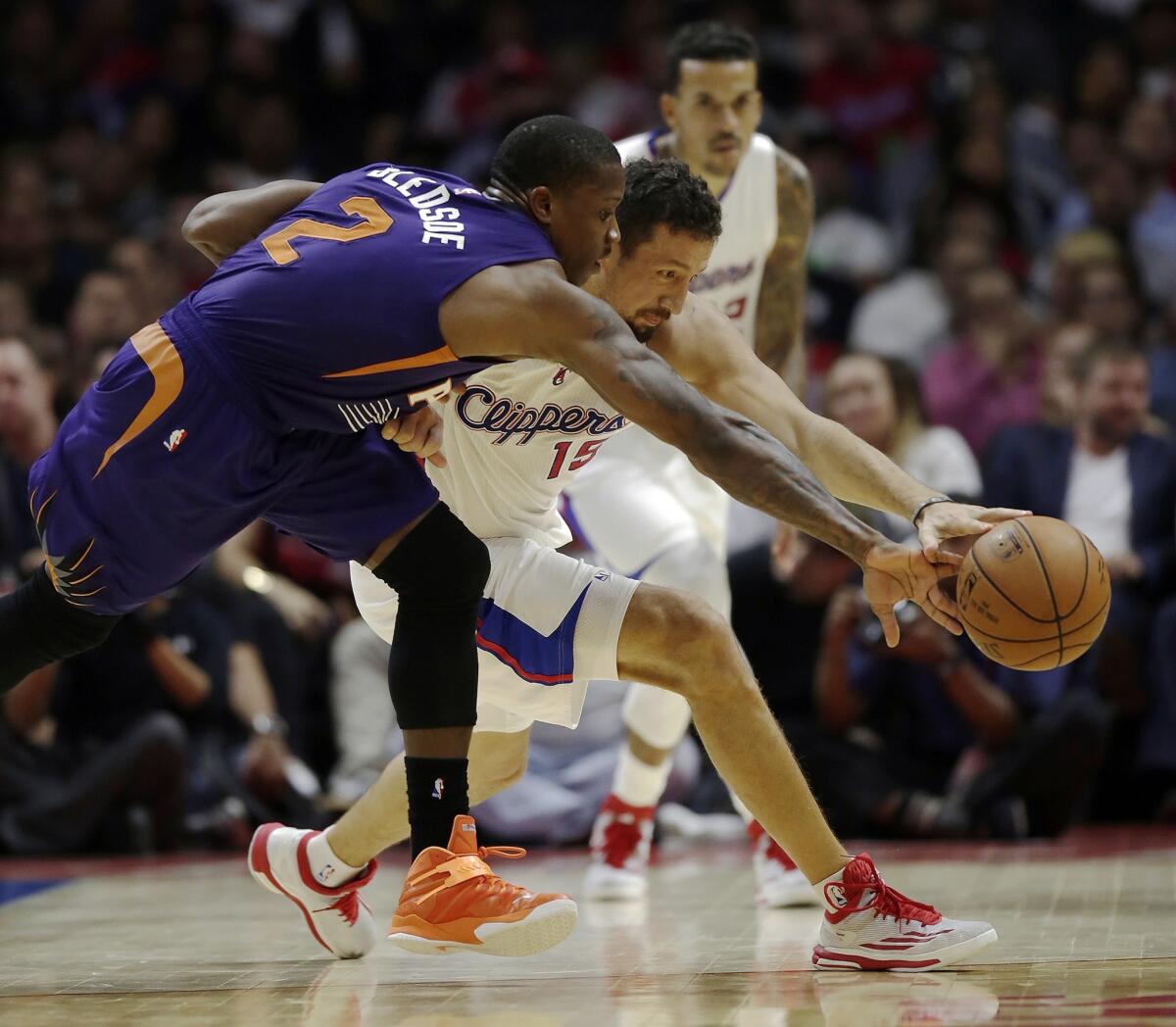 Clippers forward Hedo Turkoglu battles with Suns guard Eric Bledsoe for a loose ball during a preseason game on Wednesday at Staples Center.