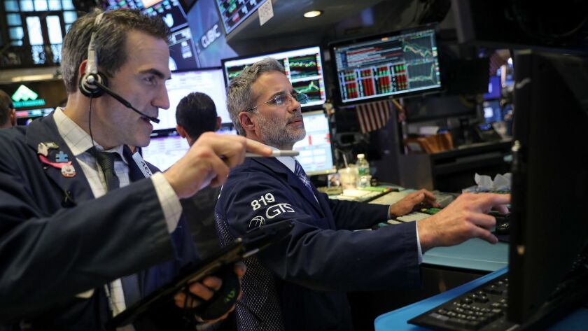 Traders and financial professionals work on the floor of the New York Stock Exchange.