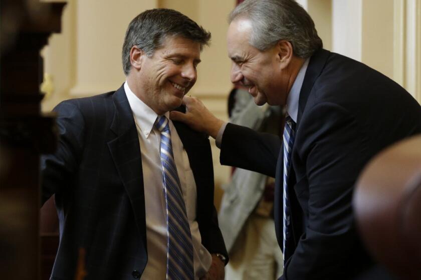 Lt. Gov. Bill Bolling, right, talks with a legislator at the Richmond Capitol earlier this month.