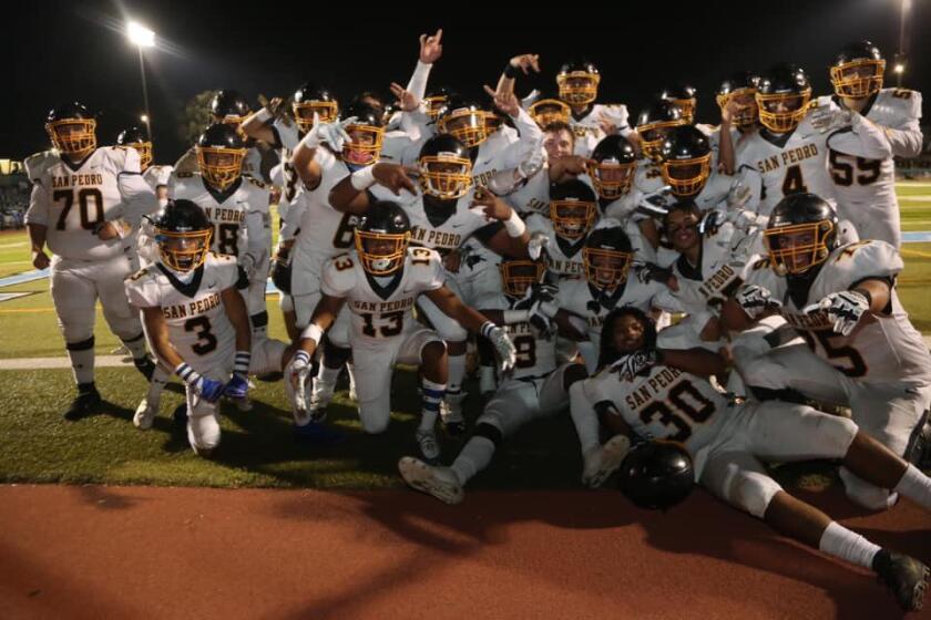 San Pedro football players celebrate after completing a 9-1 season.