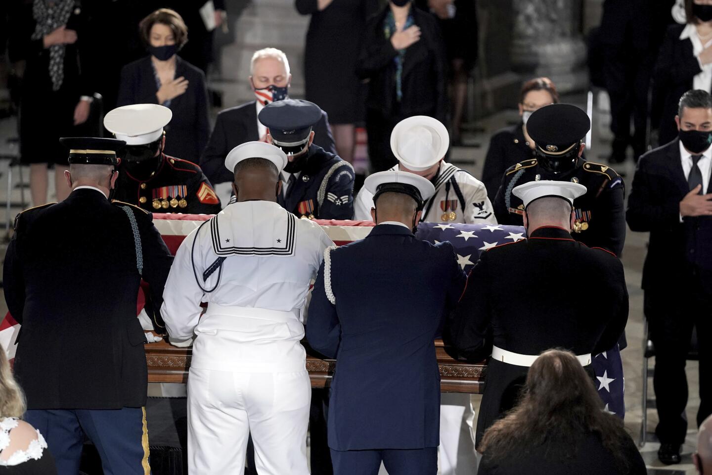 Honor guard places the casket of Justice Ruth Bader Ginsburg in Statuary Hall of the U.S. Capitol to lie in state