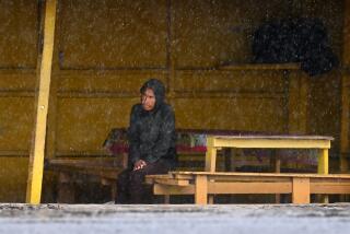 Ensenada, Mexico August 19, 2023-A man takes shelter as Tropical Storm Hilary makes landfall in Ensenada, Mexico Sunday.`(Wally Skalij/Los Angles Times)