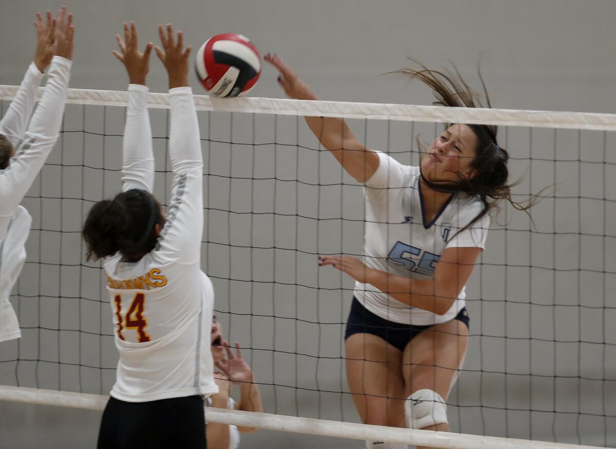 Marina's Helen McMullin, right, spikes the ball in a nonleague match at Ocean View on Sept. 3.