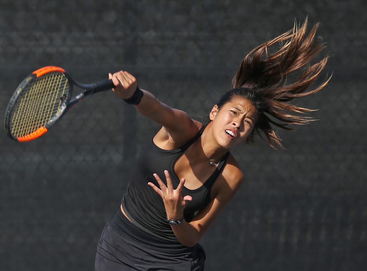 Huntington Beach’s Cindy Huynh hits a solid serve in a Wave League match at Laguna Beach on Oct. 10.