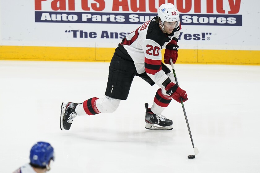 New Jersey Devils' Michael McLeod (20) looks to pass the puck during the second period of the team's NHL hockey game against the New York Islanders on Thursday, May 6, 2021, in Uniondale, N.Y. (AP Photo/Frank Franklin II)