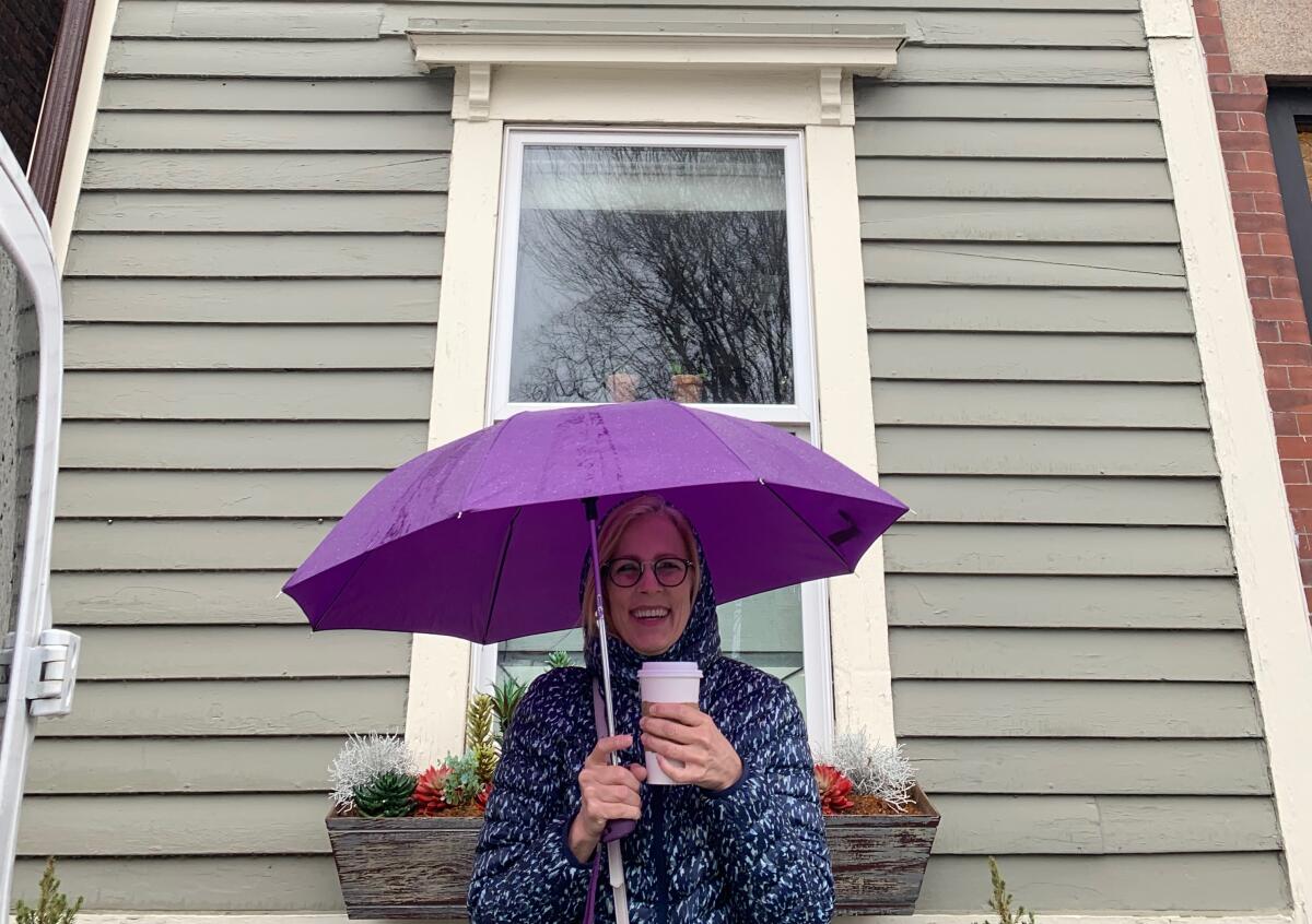 Amy Hubbard holds an umbrella