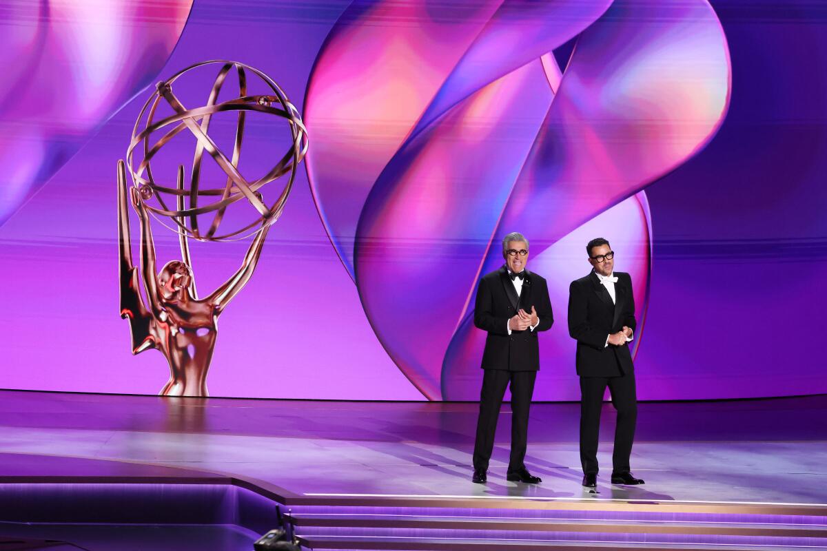 Eugene and Dan Levy on the Emmys stage.