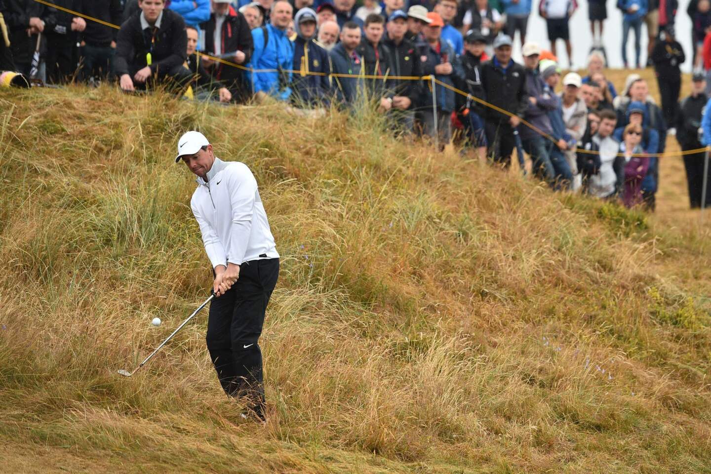 Northern Ireland's Rory McIlroy chips out of the rough on the second hole during the second round of the British Open in Carnoustie, Scotland.