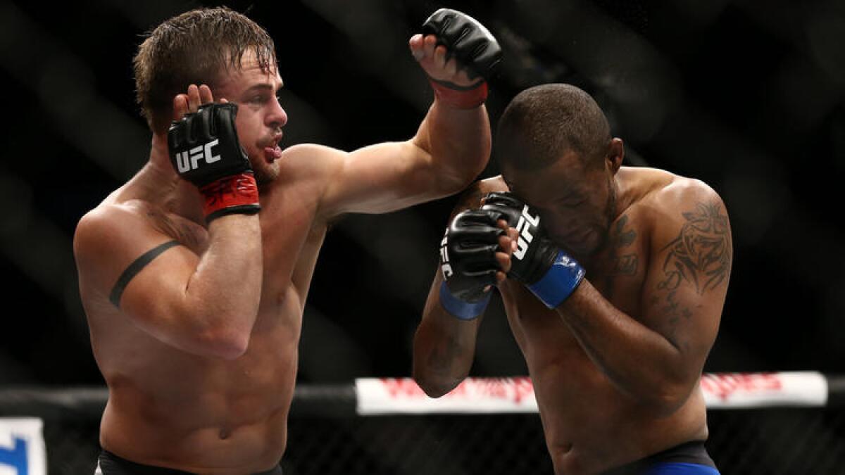 Terrion Ware, right, covers up as Cody Stamann strikes with a left during their fight at UFC 213.