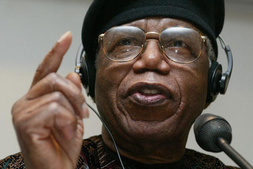 Nigerian author Chinua Achebe gestures during a news conference held during Frankfurt bookfair October 12, 2002.