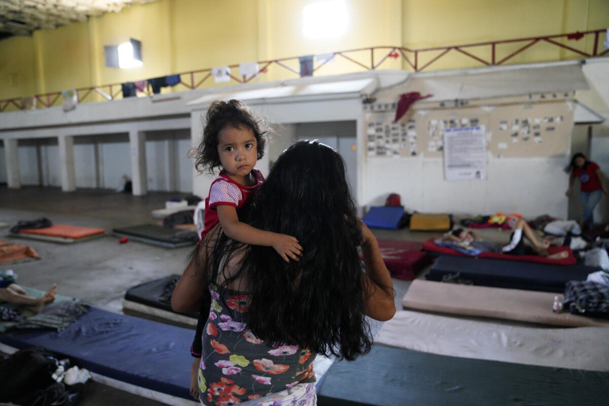 Clementa Perez and her two children sleep on mattresses on the floor at the Hijo Prodigo shelter in Mexicali, Mexico.