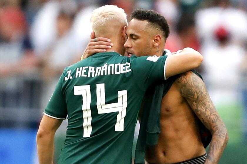 Mexico's Javier Hernandez (14) embraces Brazil's Neymar after their round of 16 match at the 2018 soccer World Cup in the Samara Arena, in Samara, Russia, Monday, July 2, 2018. Brazil won 2-0. (AP Photo/Eduardo Verdugo)