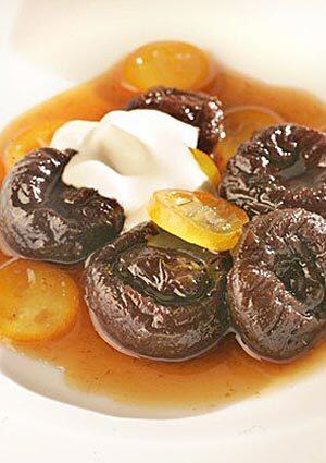 Earl Grey tea-poached pruces with glazed kumquats.