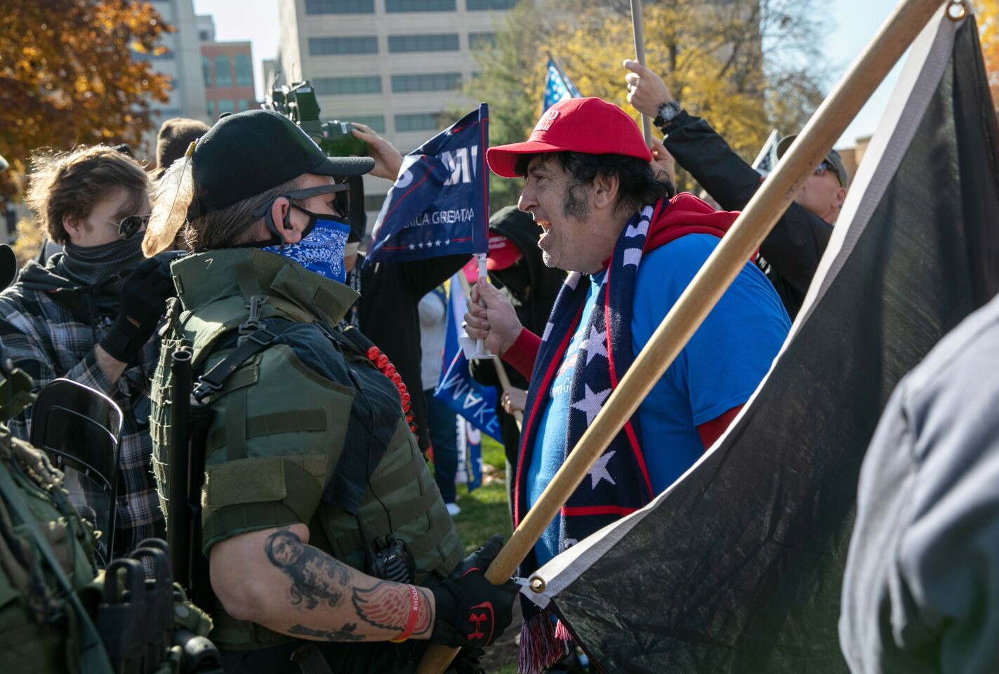 An unmasked Trump supporter shouts down counterprotesters during a demonstration in Lansing, Mich.