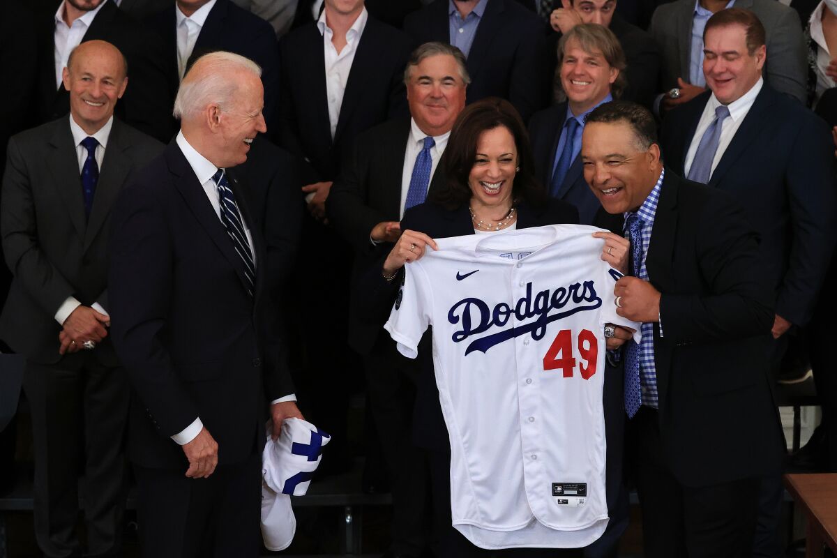 Dodgers Manager Dave Roberts presents Vice President Kamala Harris with a jersey