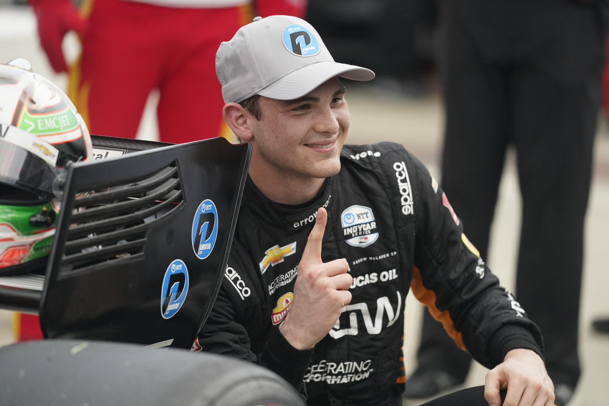 FILE - Pato O'Ward, of Mexico, smiles after winning the pole for the IndyCar.