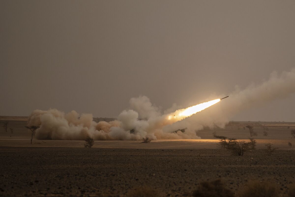FILE - A launch truck fires the High Mobility Artillery Rocket System (HIMARS) 