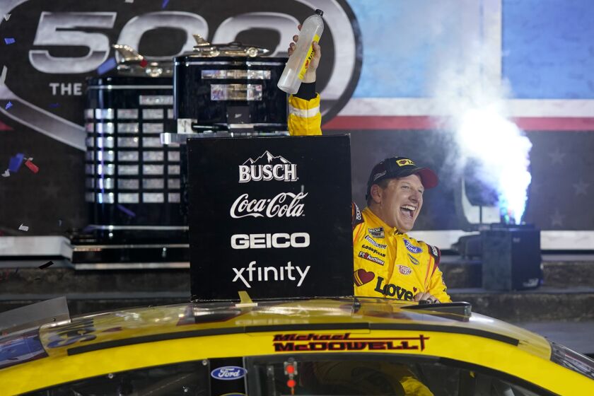 Michael McDowell celebrates after winning the NASCAR Daytona 500 auto race.