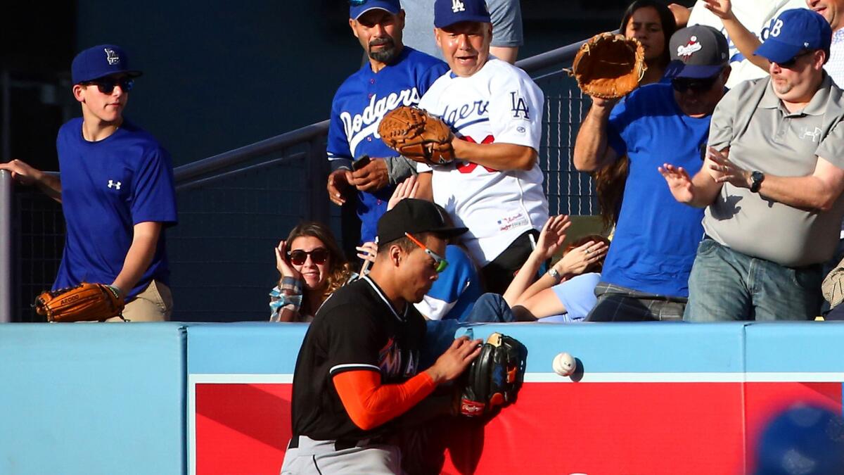 Marlins right fielder Giancarlo Stanton can't make the catch on deep fly ball hit by Dodgers third baseman Alex Guerrero, who ended up with a triple in the fourth inning Wednesday.