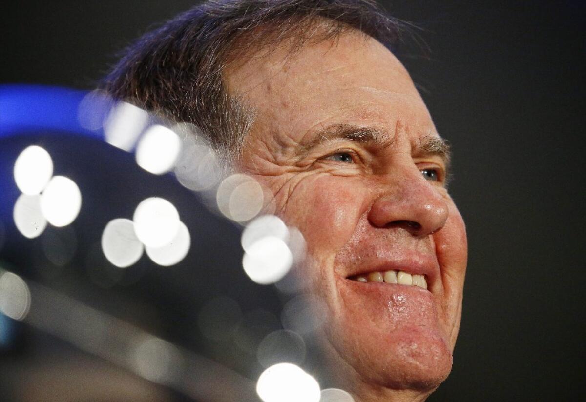 Patriots Coach Bill Belichick smiles while speaking to the media next to the Vince Lombardi Trophy during a press conference on Feb. 6.