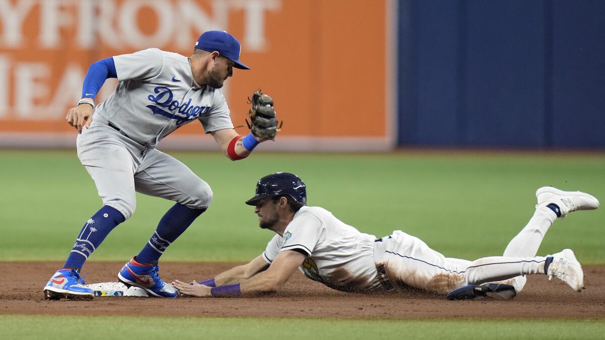 Tampa Bay's Josh Lowe steals second base in front of Dodgers shortstop Miguel Rojas in the first inning.