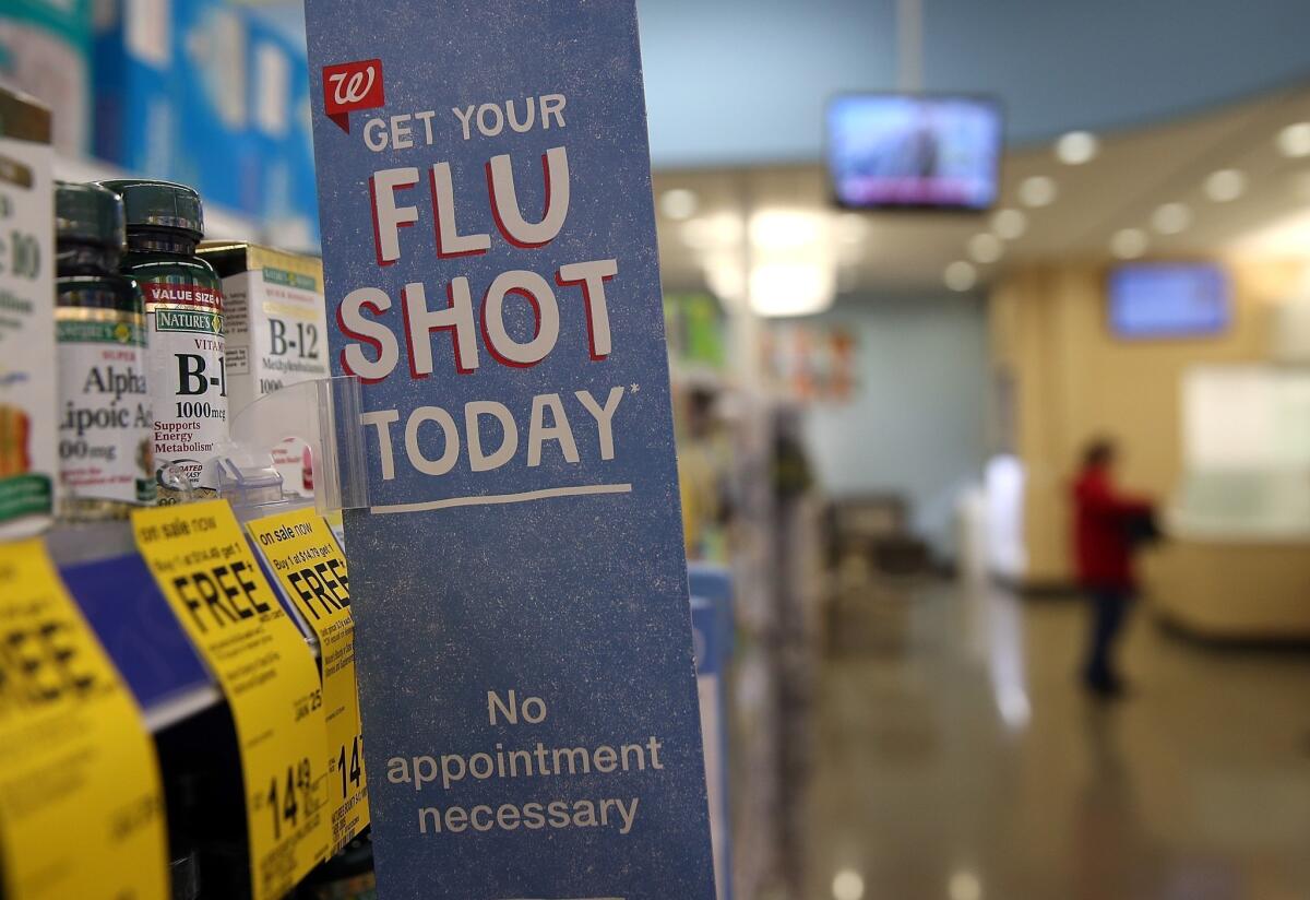 A sign advertising flu shots is displayed at a Walgreens pharmacy earlier this year in Concord, Calif.
