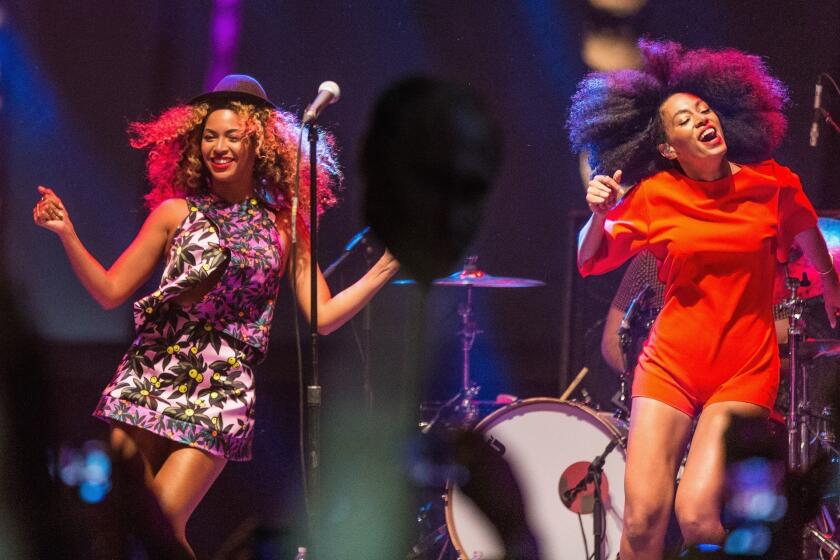 Beyonce, left, performs with her sister Solange Knowles during Day 2 of the 2014 Coachella Valley Music & Arts Festival at the Empire Polo Club in Indio, Calif.