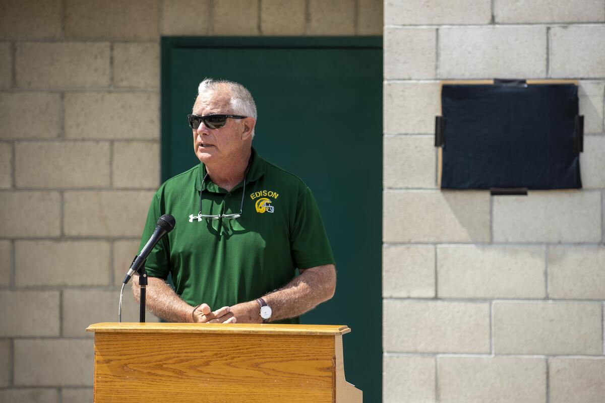 Bruce Belcher speaks to a crowd during the official naming of the Edison weight room on Friday.