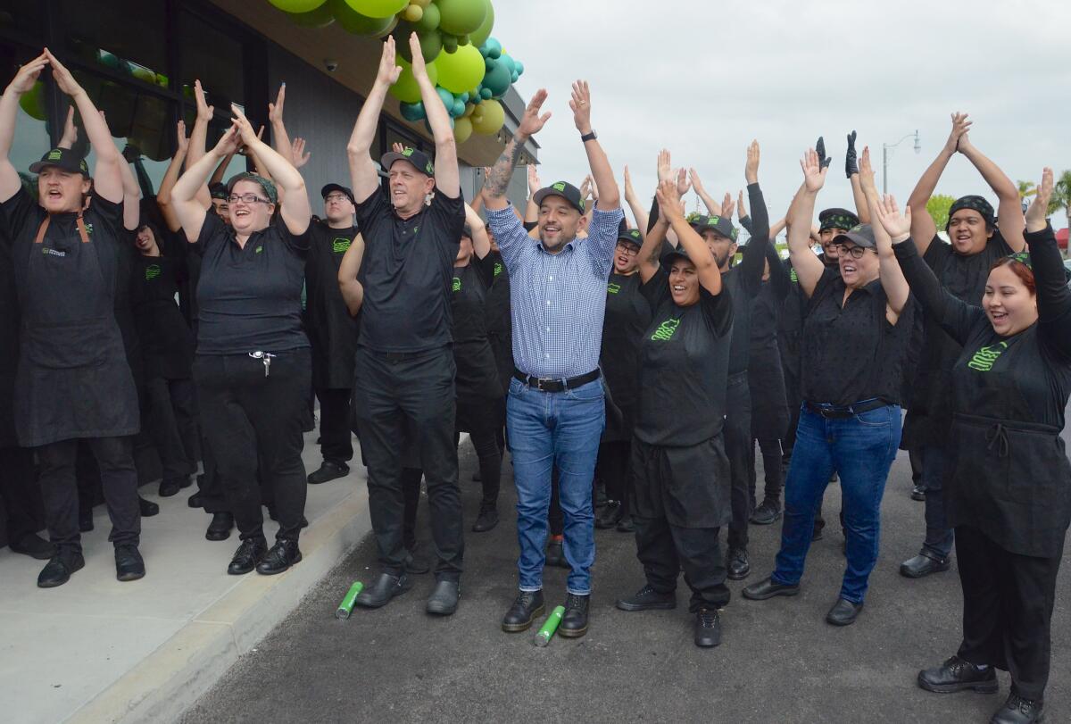 In honor of Costa Mesa opening of the new Shake Shack location, employees do the traditional "Shack Clap."