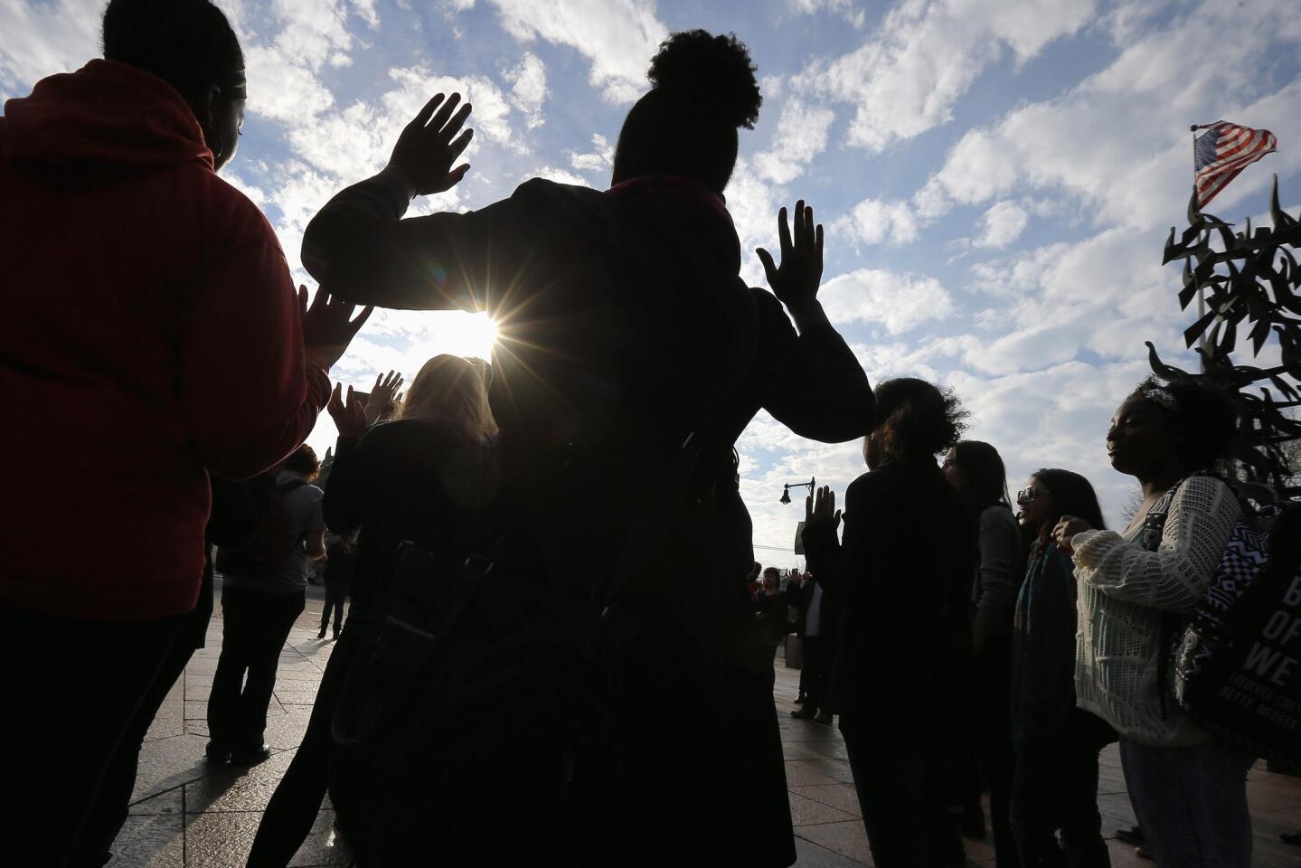 Demonstrators participate in a nationwide "Hands Up, Walk Out" protest Dec. 1 at Boston University. The protesters say charges should have been filed in the fatal police shooting of Michael Brown in Ferguson, Mo.