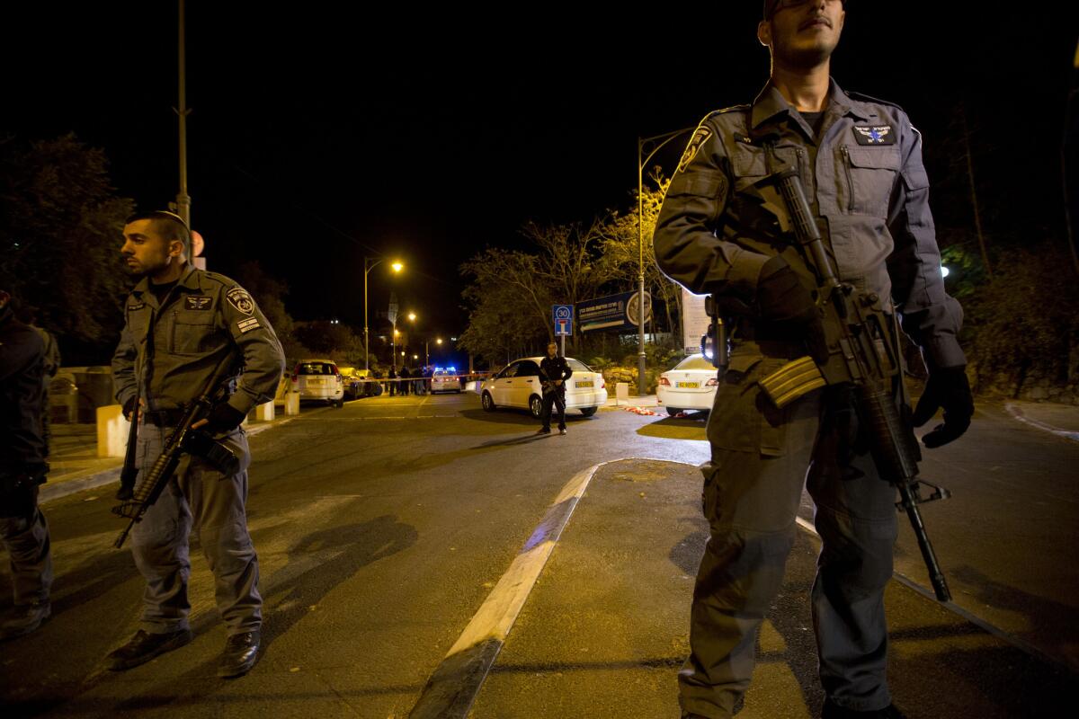Israeli police officers stand guard at the scene of an apparent assassination attempt last month in Jerusalem.